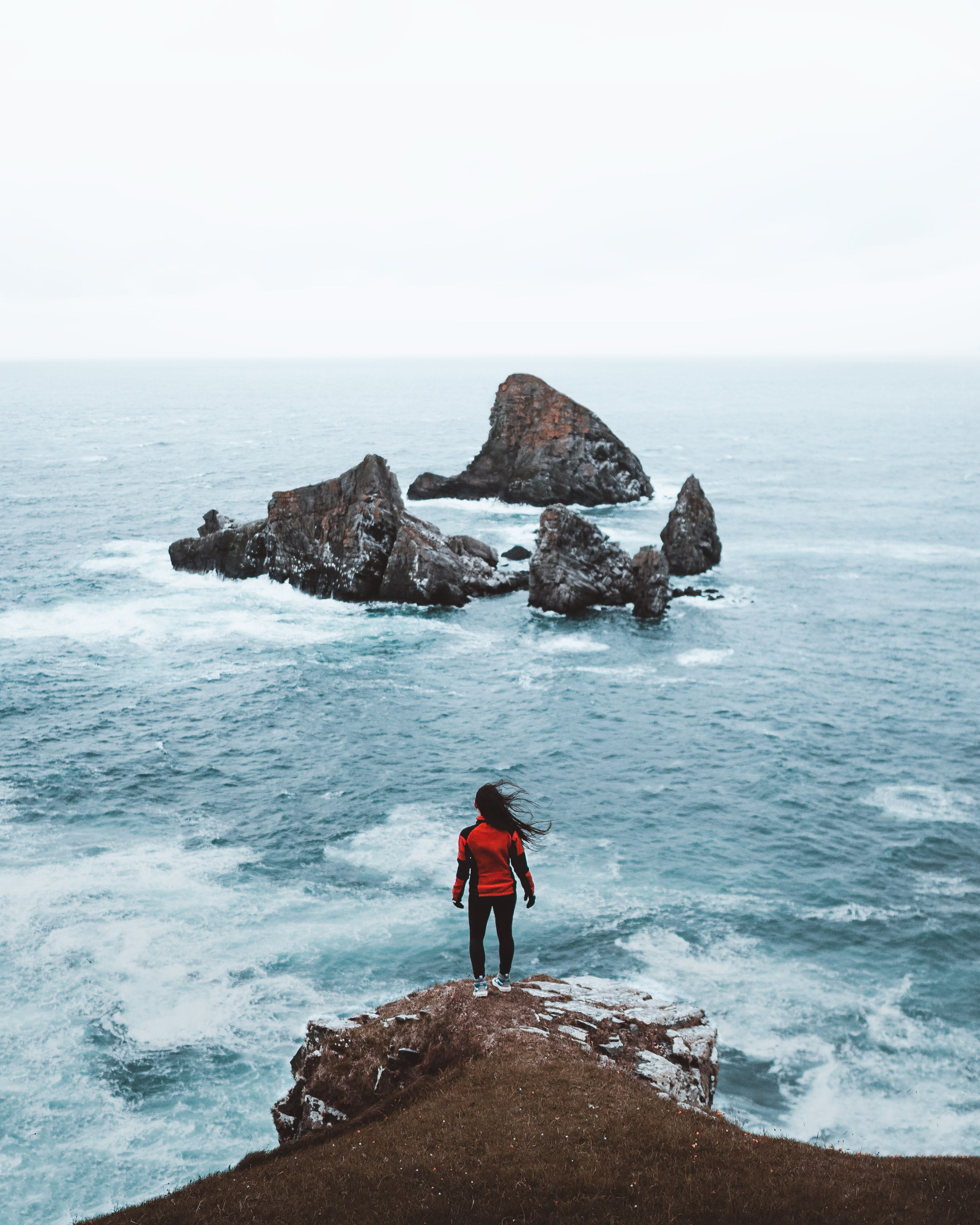 Sarah Afiqah Rodgers standing my the edge of the sea on a cliff