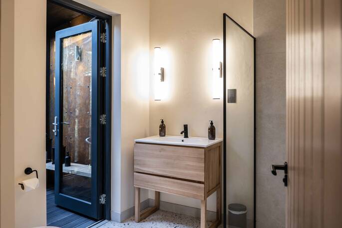 Bathroom with a walk in shower, waterless eco loo and sink