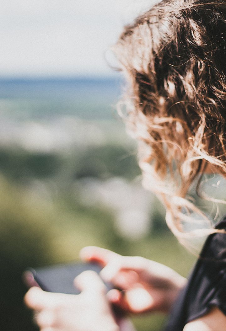 Person in nature using mobile phone 