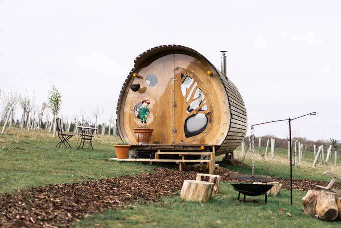 Hedgehog Hall exterior with firepit, and outdoor seating area 