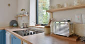 Kitchen equipped with an induction hob, oven, toaster, kettle and a fridge-freezer