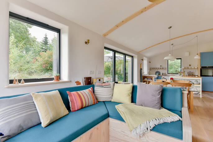 Open plan kitchen and lounge with an L shaped sofa