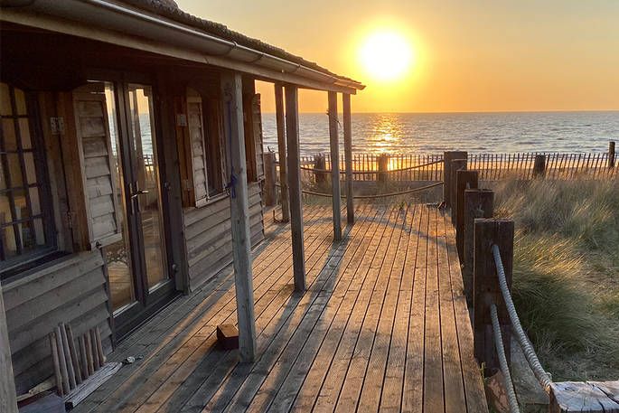 The Beach House decking with view of the sea, beach and sunset 